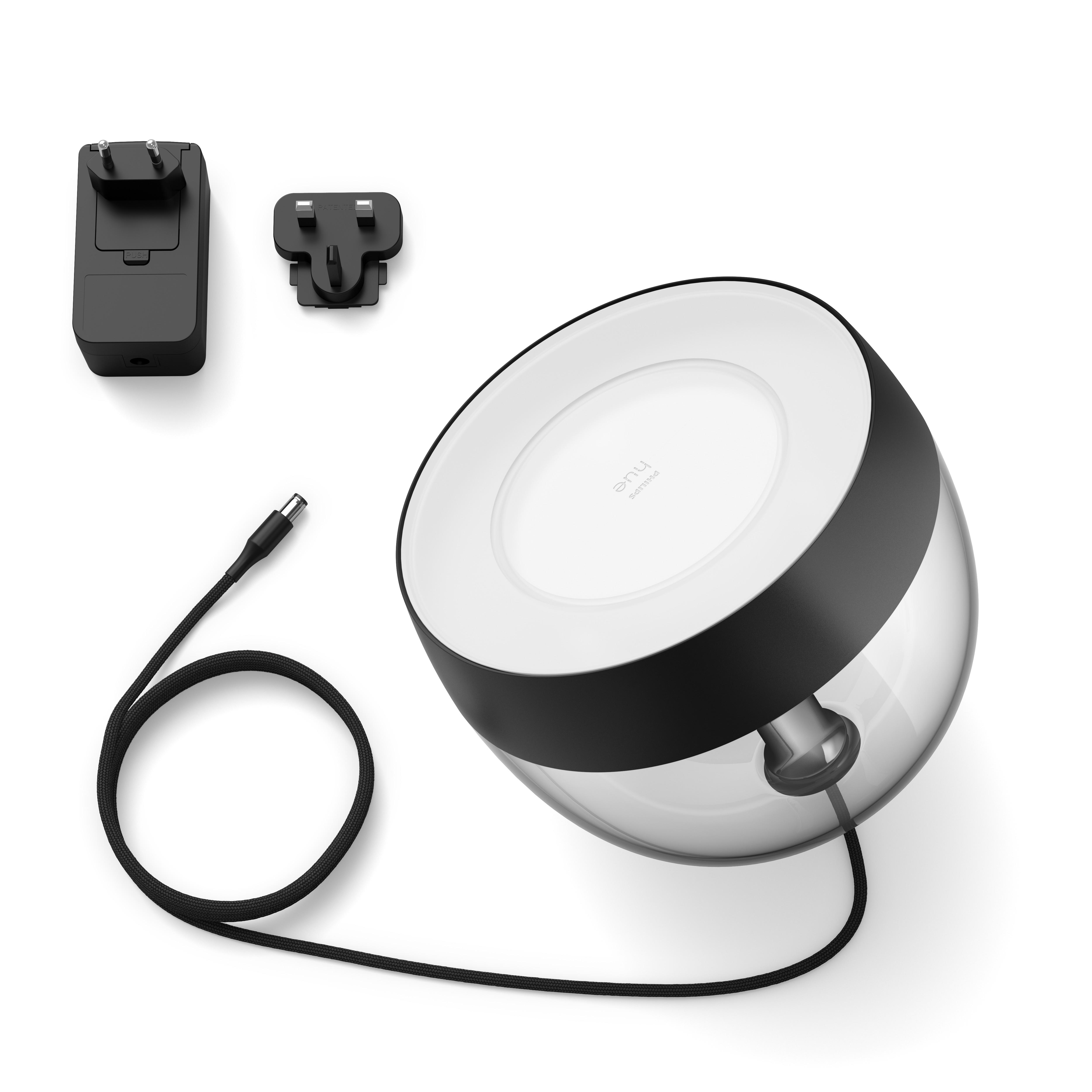 Philips Hue Lampe mit Zubehör. Schwarzer Sockel, weißer Deckel, Glaskugel.