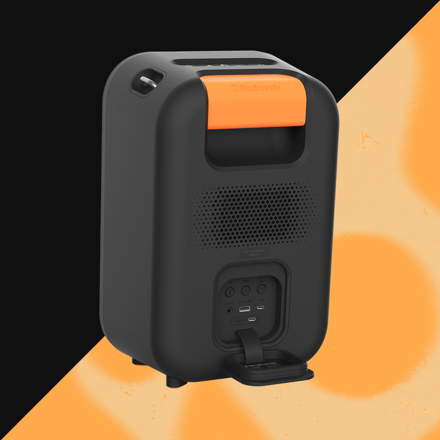 Black and orange Skullcandy speaker on a black and orange gradient background.