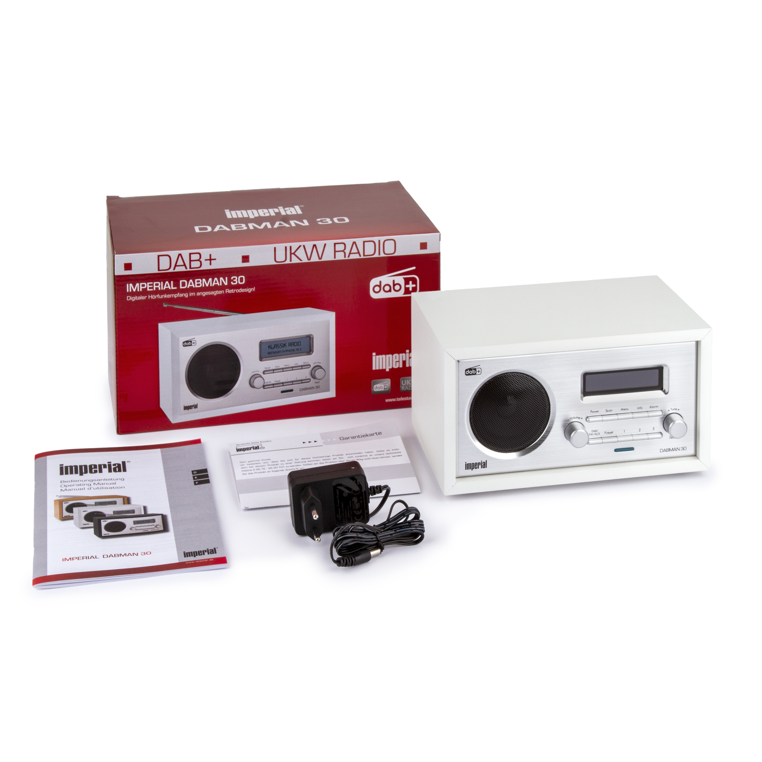 A white Imperial DABMAN 30 radio, box, and accessories. Box displays 'DAB+' and 'UKW RADIO'. Manuals and power adapter are also visible.