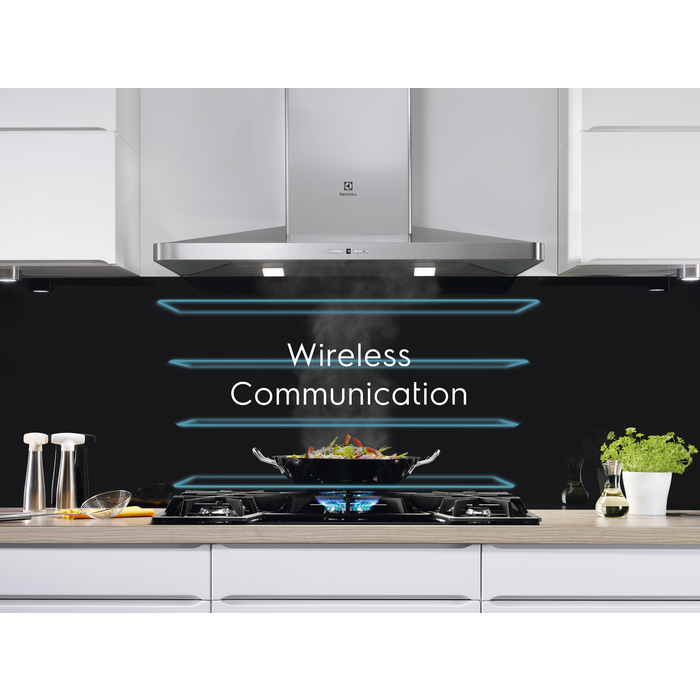 Rozsdamentes acél páraelszívó a főzőlap felett, fazékkal és kék lánggal. Szöveg: 'Wireless Communication'.