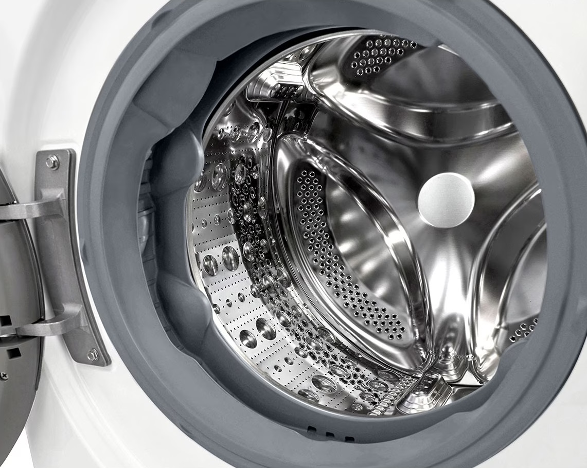 Otwarty bęben pralki, wnętrze ze stali nierdzewnej, szara uszczelka gumowa, biały.