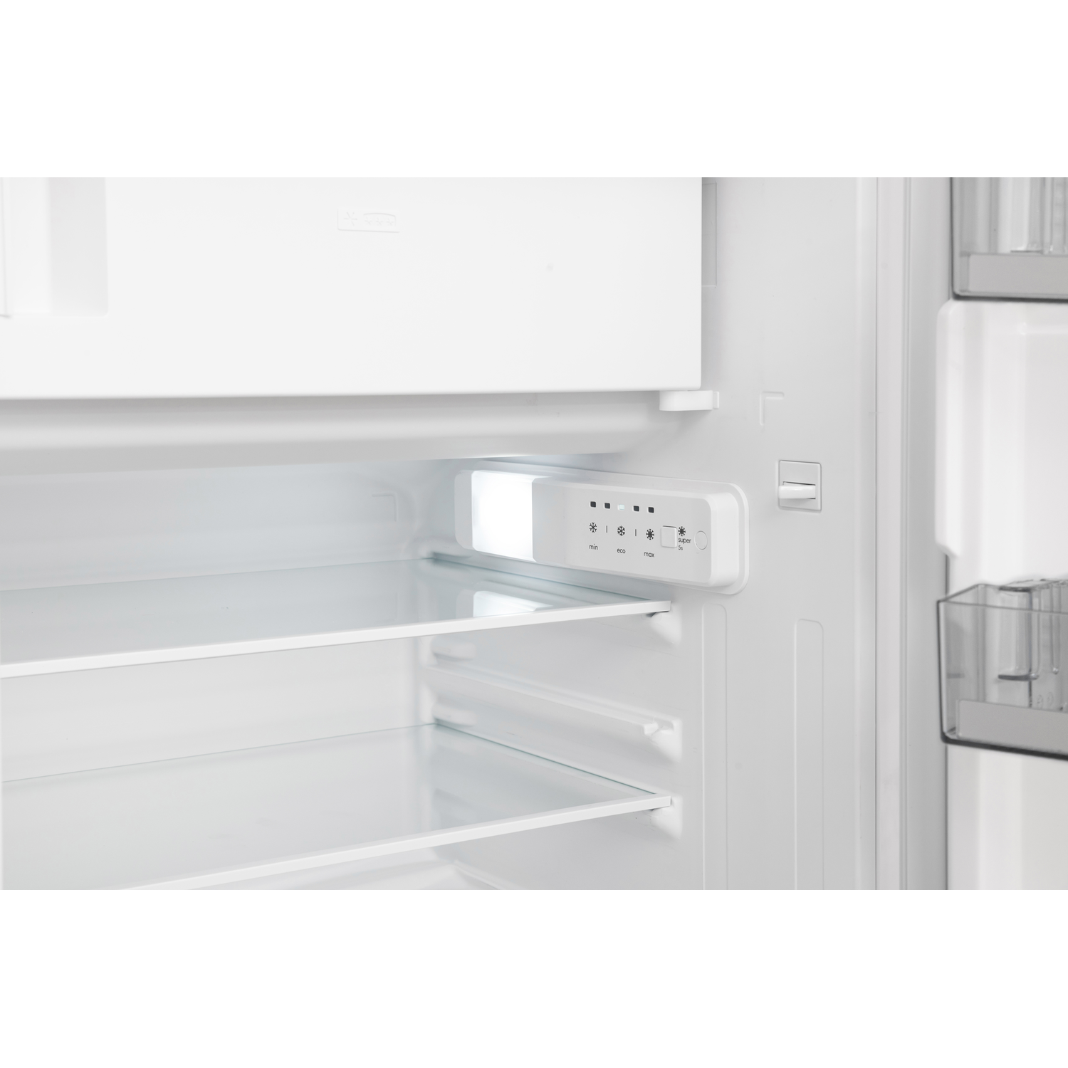 Inside a white refrigerator. Visible are shelves, a light, and controls.