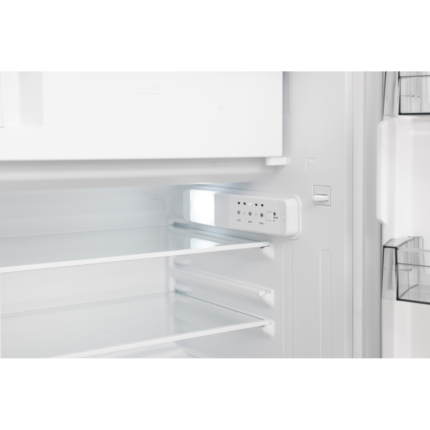 Inside a white refrigerator, with shelves and a light, empty.