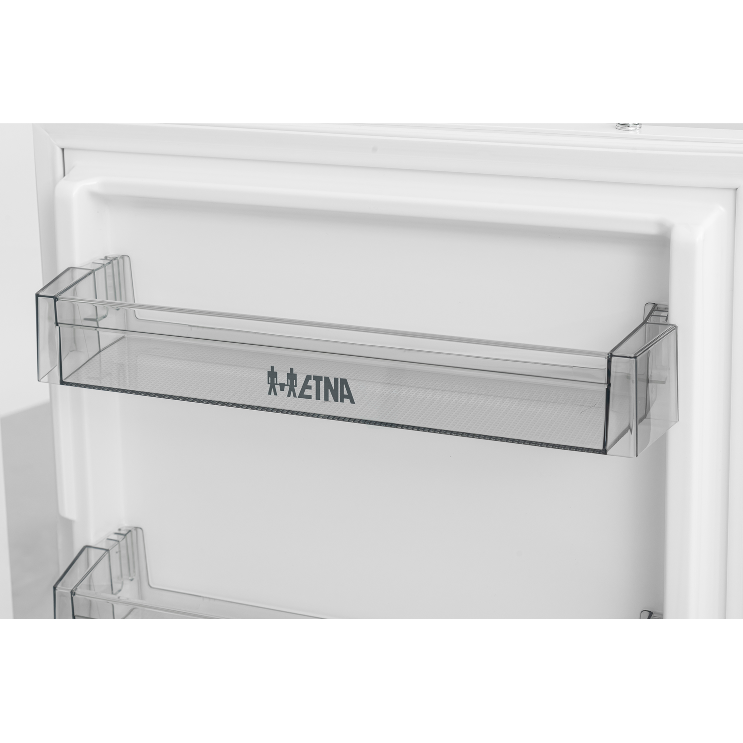 Refrigerator interior with a clear shelf and the ETNA logo.