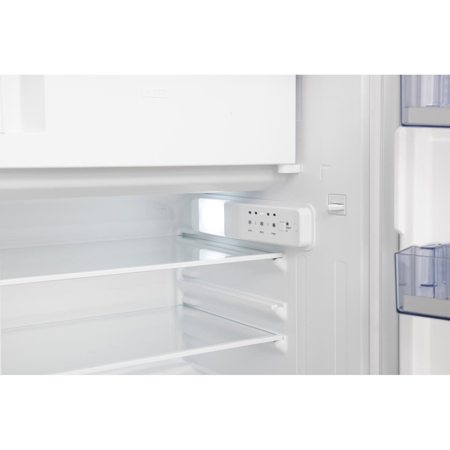 The inside of a refrigerator with shelves and control panel.