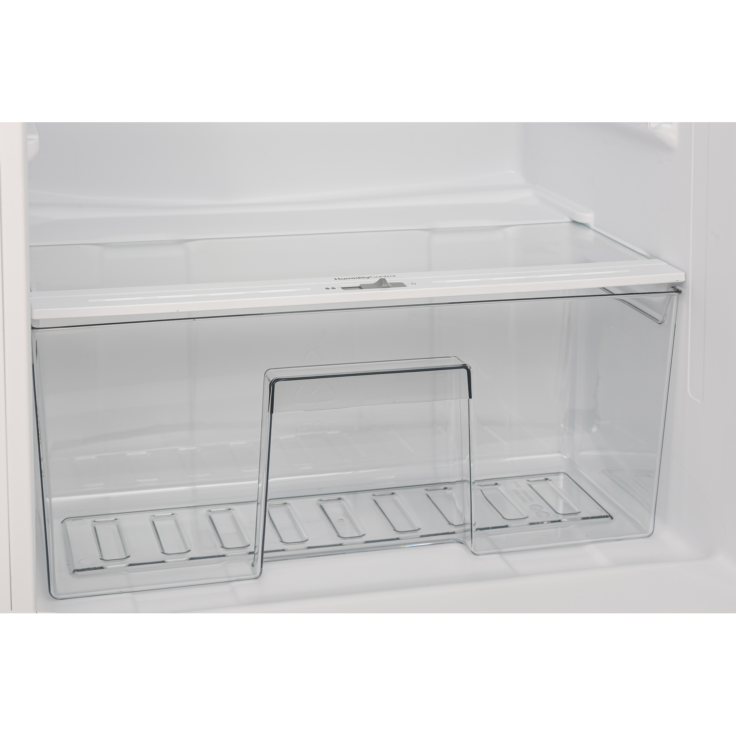 Inside a clear refrigerator, there is a clear vegetable drawer with a shelf above it.