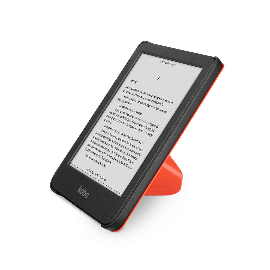 Lector electrónico negro y naranja en un soporte, mostrando texto. Un libro está en pantalla.