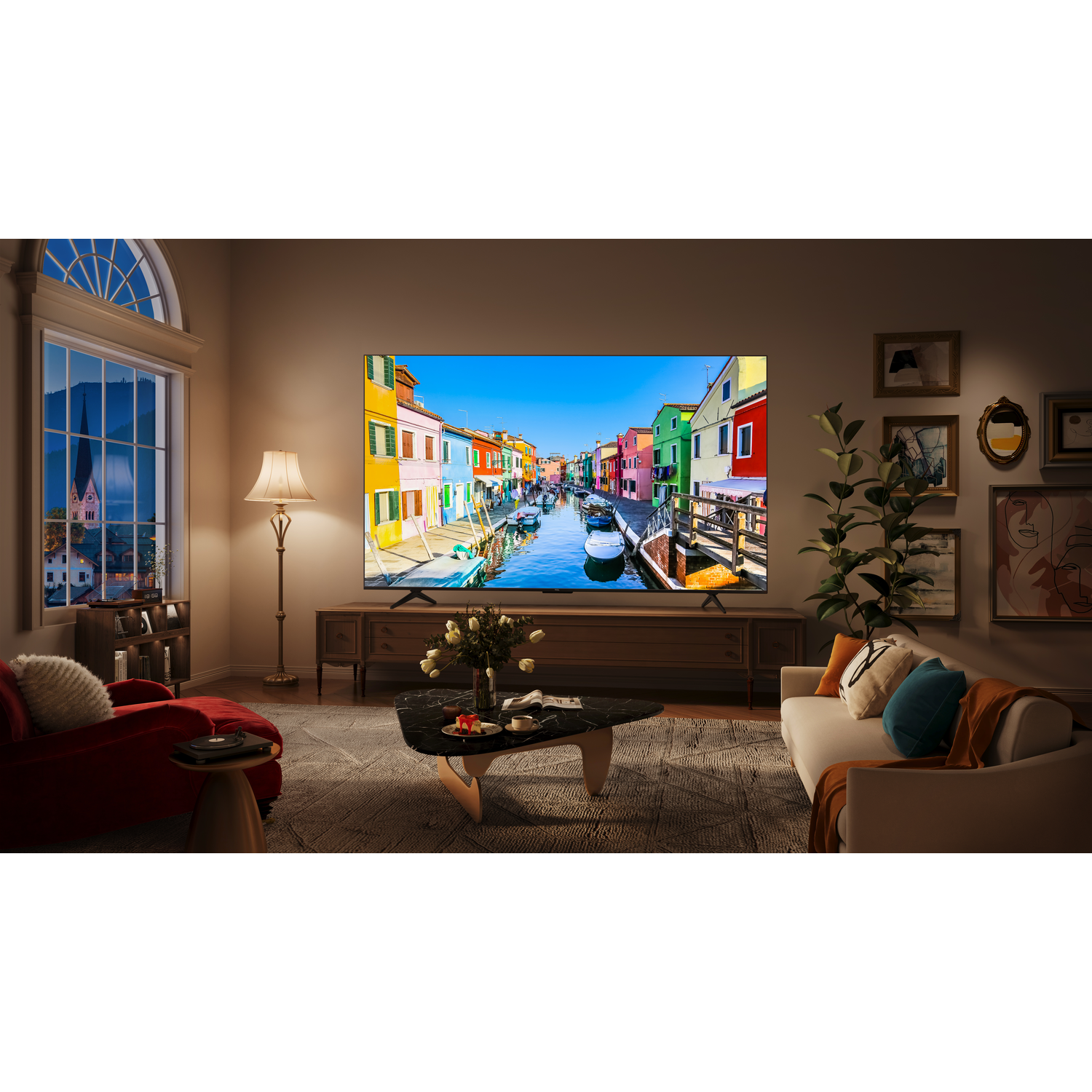 Wohnzimmer mit Fernseher, Sofa und Fenster mit Blick auf eine farbenfrohe Stadt.
