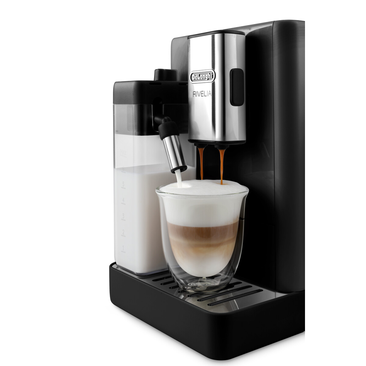 Coffee machine pouring coffee into a glass with milk.