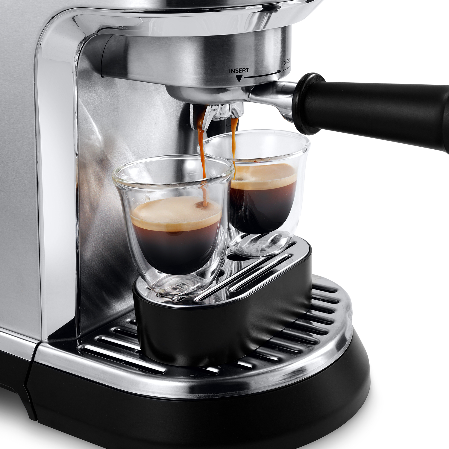 Espresso machine brewing coffee into two glass cups.
