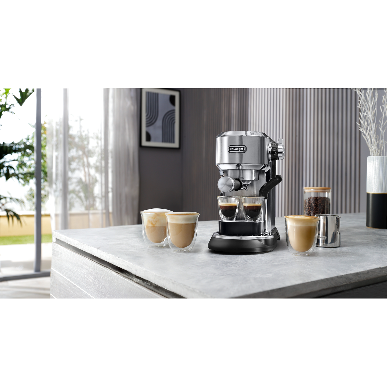 Espresso machine with two drinks on a marble surface with coffee beans and cups.