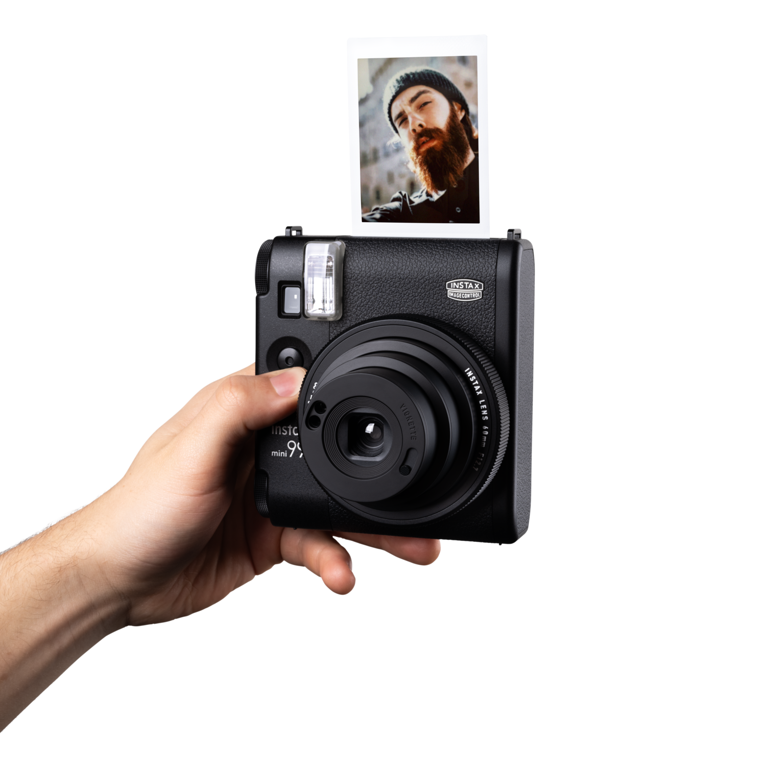 Een zwarte Instax-camera wordt door een hand vastgehouden. Een afgedrukte foto van een man staat boven de camera.