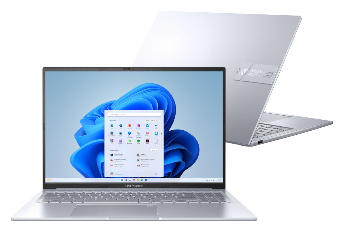 Srebrny laptop z systemem Windows 11 na ekranie, z innym laptopem z tyłu.