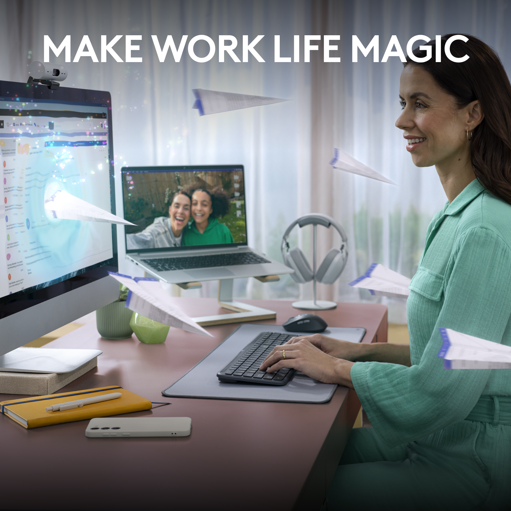 Una donna a una scrivania con un computer, circondata da aeroplanini di carta, con il testo 'MAKE WORK LIFE MAGIC'.