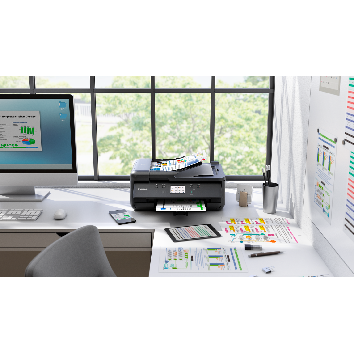 Office desk with printer, monitor, and papers. A window with a green view.