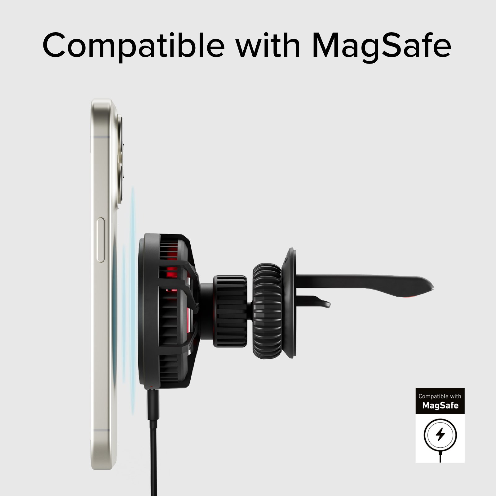 Telefon z podłączoną ładowarką MagSafe. Telefon jest srebrny, a ładowarka czarna.