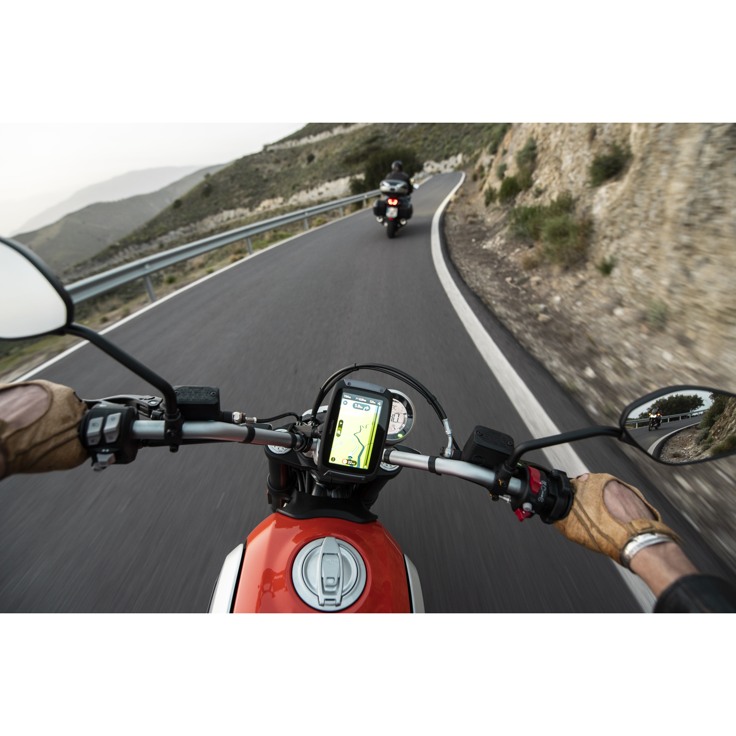 POV van motorrijder met GPS-navigatie die de weg toont.