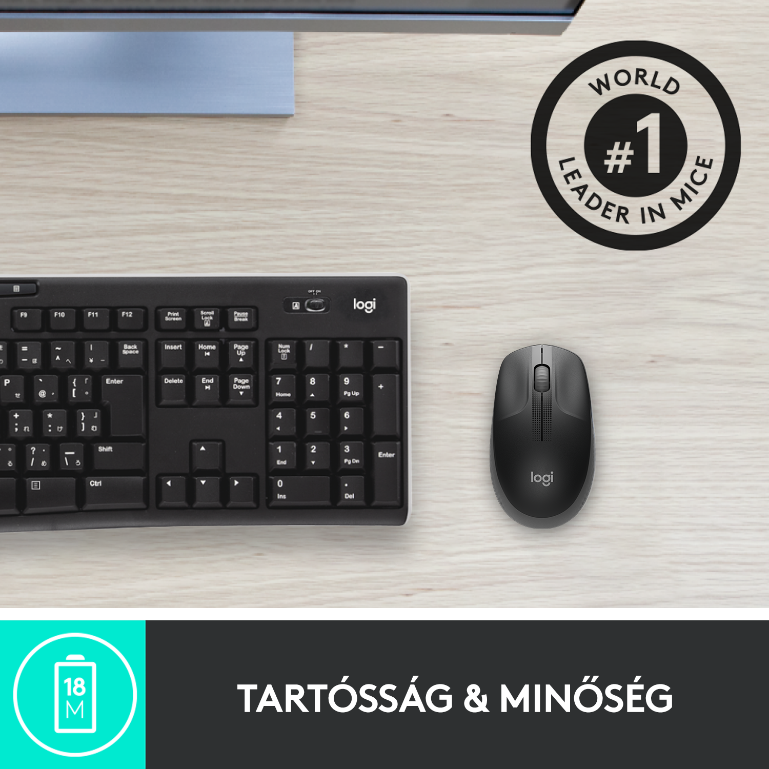 Fekete Logitech egér és billentyűzet fa asztalon, 'World #1 Leader' matricával.