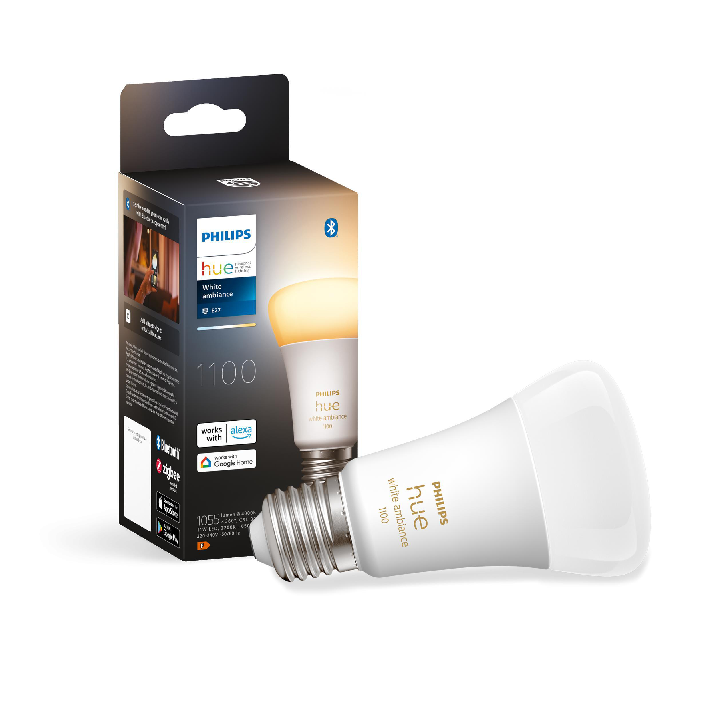 Eine weiße Philips Hue Glühbirne und ihre Verpackung, vor weißem Hintergrund.