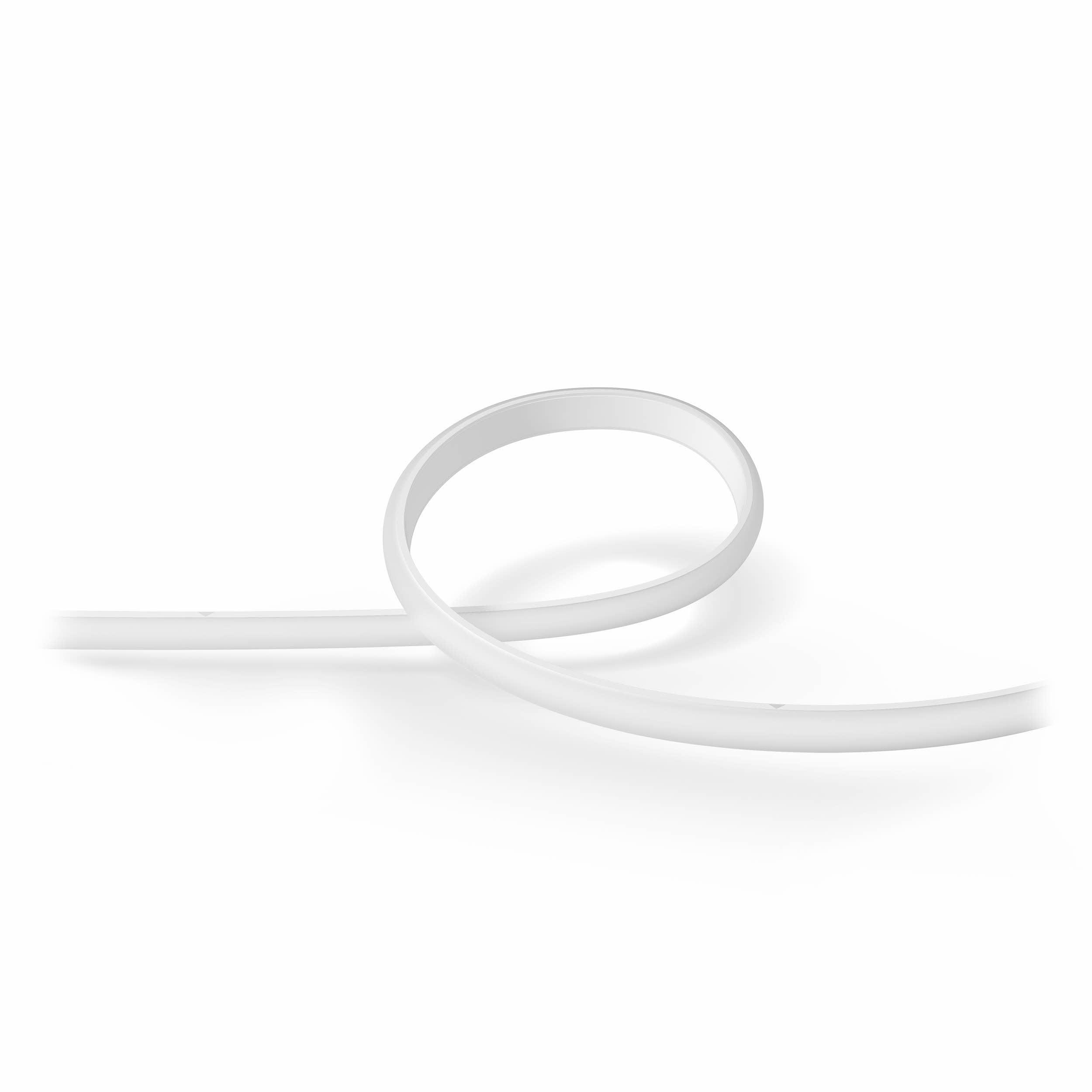 Ein weißer, flexibler Lichtstreifen in wellenförmiger Form, isoliert auf weißem Hintergrund.