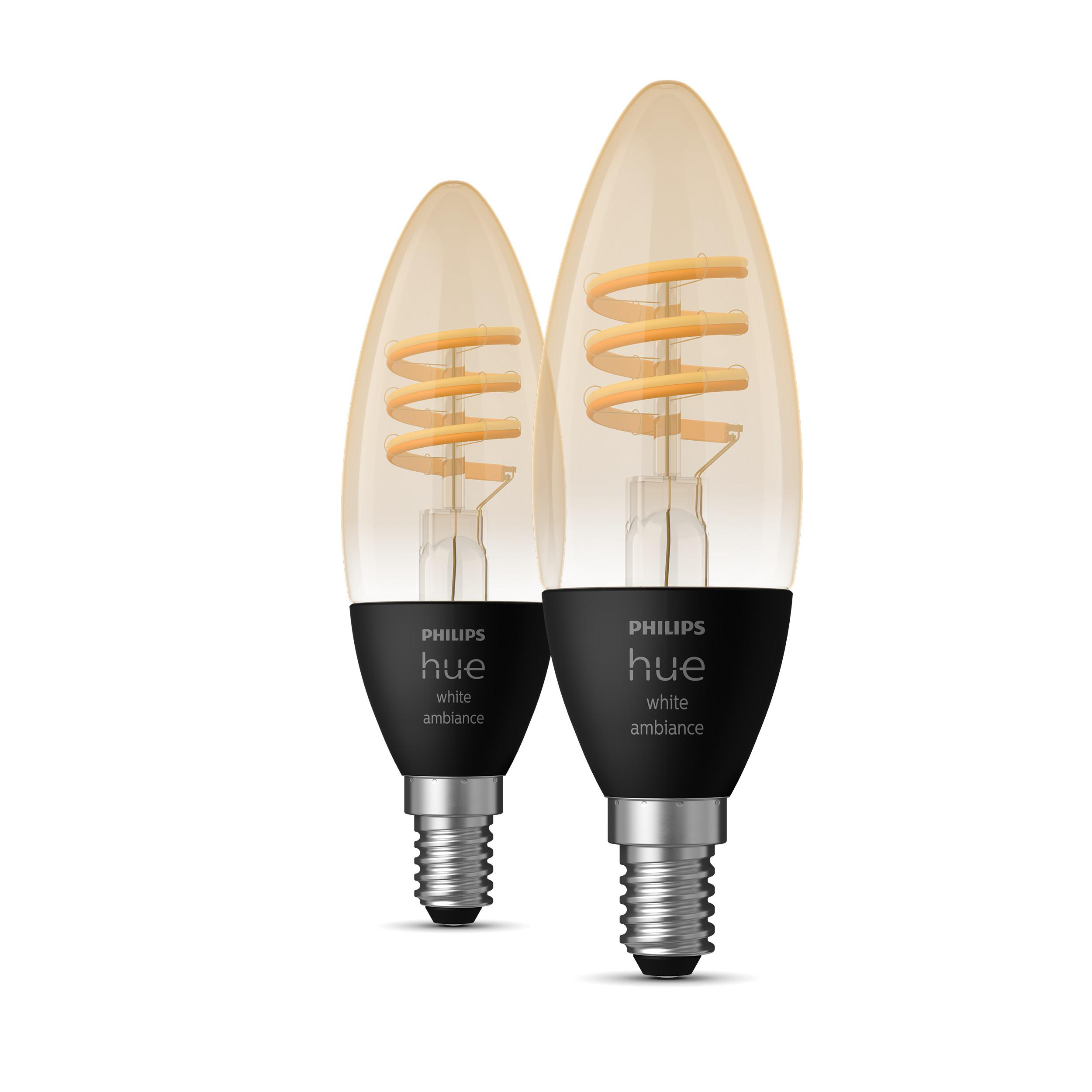 Zwei Philips Hue Glühbirnen. Amberfarbenes Glas mit gelbem Wendelfaden. Schwarze Basis mit silberner Schraubbasis.