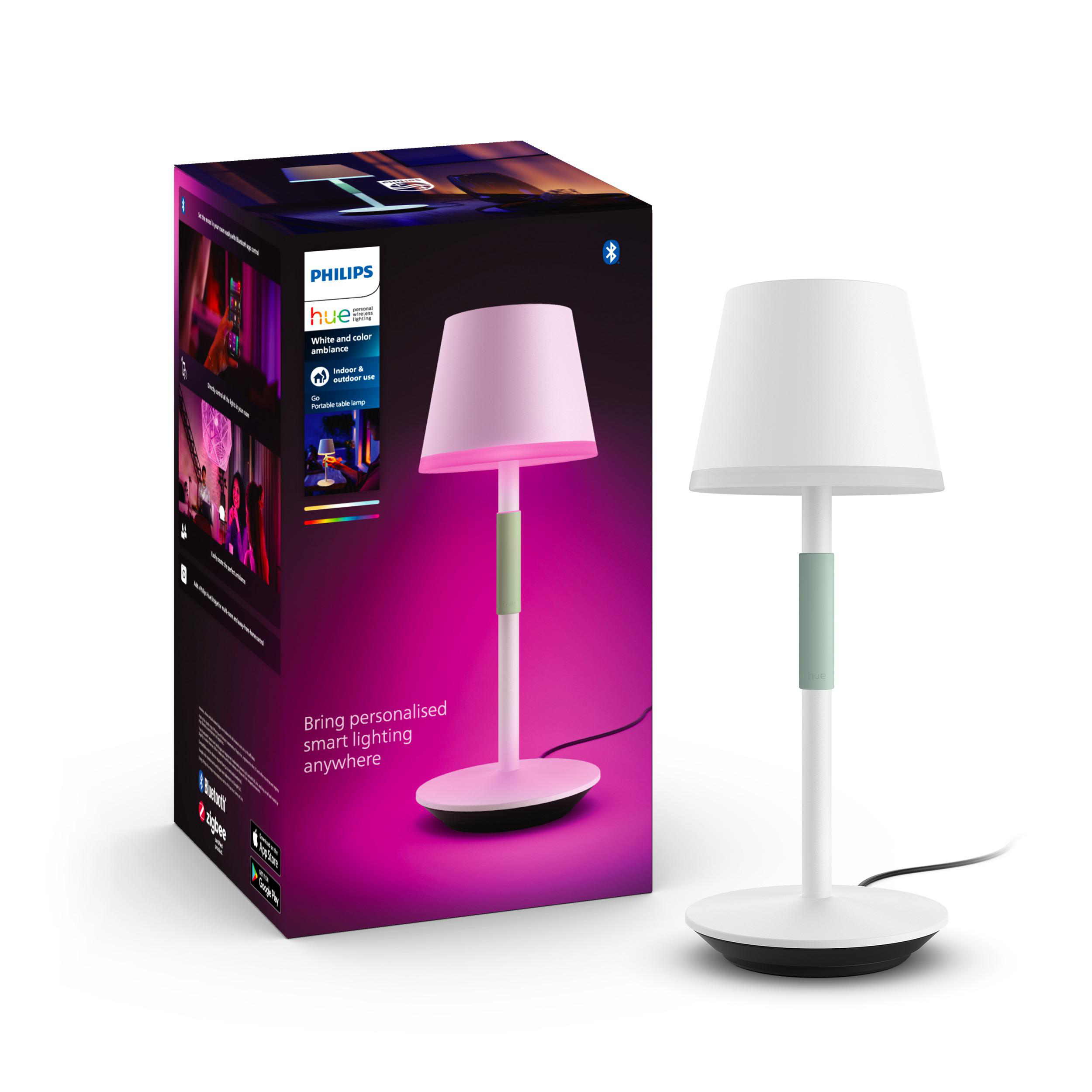Philips Hue Smart-Tischleuchte mit pinkfarbenem Lampenschirm und grünem Stiel, neben Produktbox.
