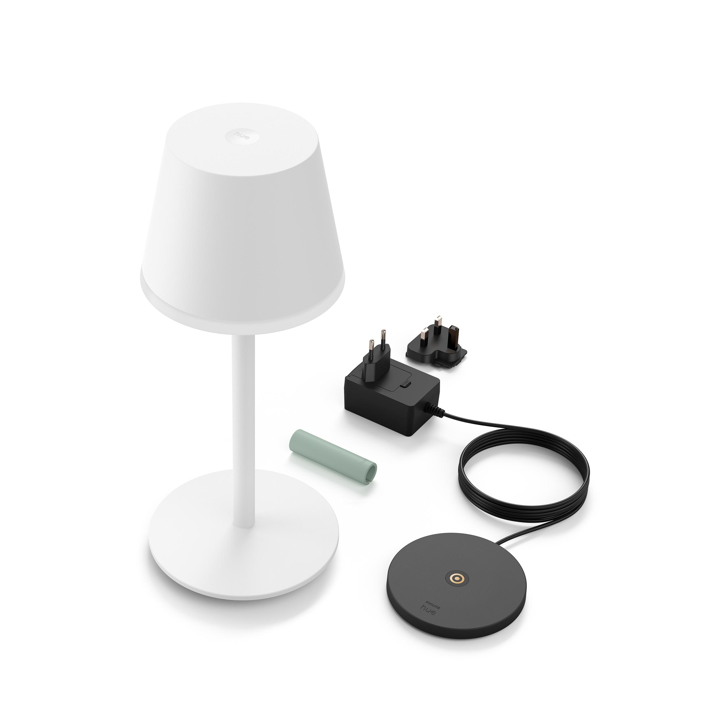 Weiße Lampe mit Ladegerät und Komponenten auf weißer Oberfläche. Licht und Komponenten.