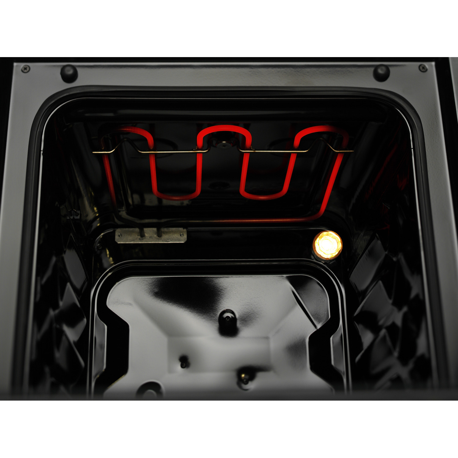 Inside of an oven, showing a red heating element and an interior light.