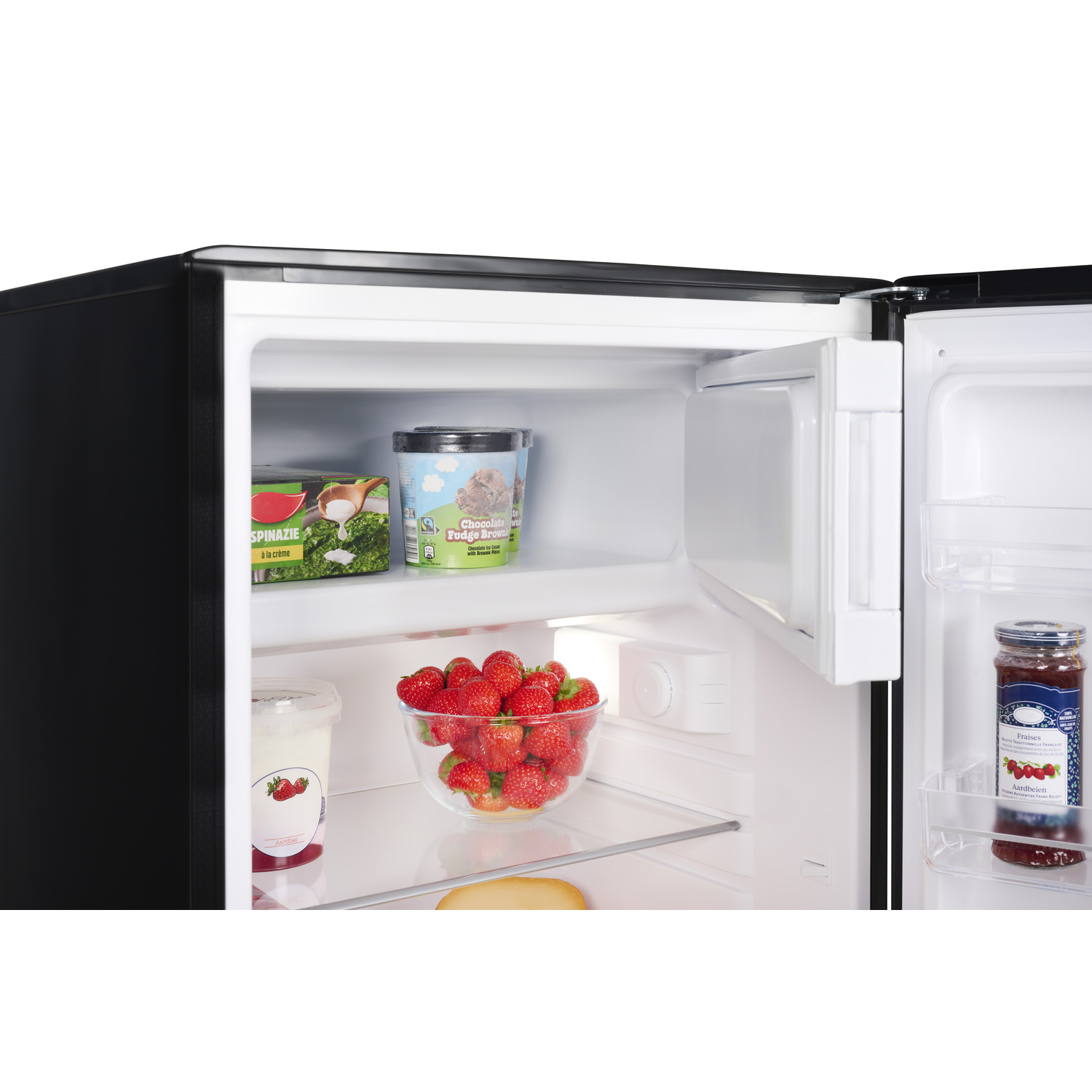Open fridge with strawberries, ice cream, and jam. Black and white interior.