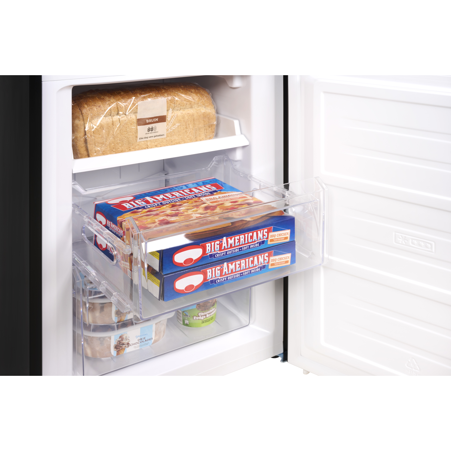 Inside a fridge with drawers containing frozen pizzas and bread. Ice cream tubs are also visible.
