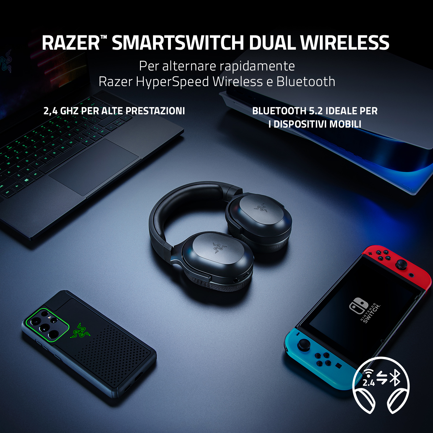 Un setup con laptop, telefono e console di gioco con cuffie Razer SmartSwitch Dual Wireless.