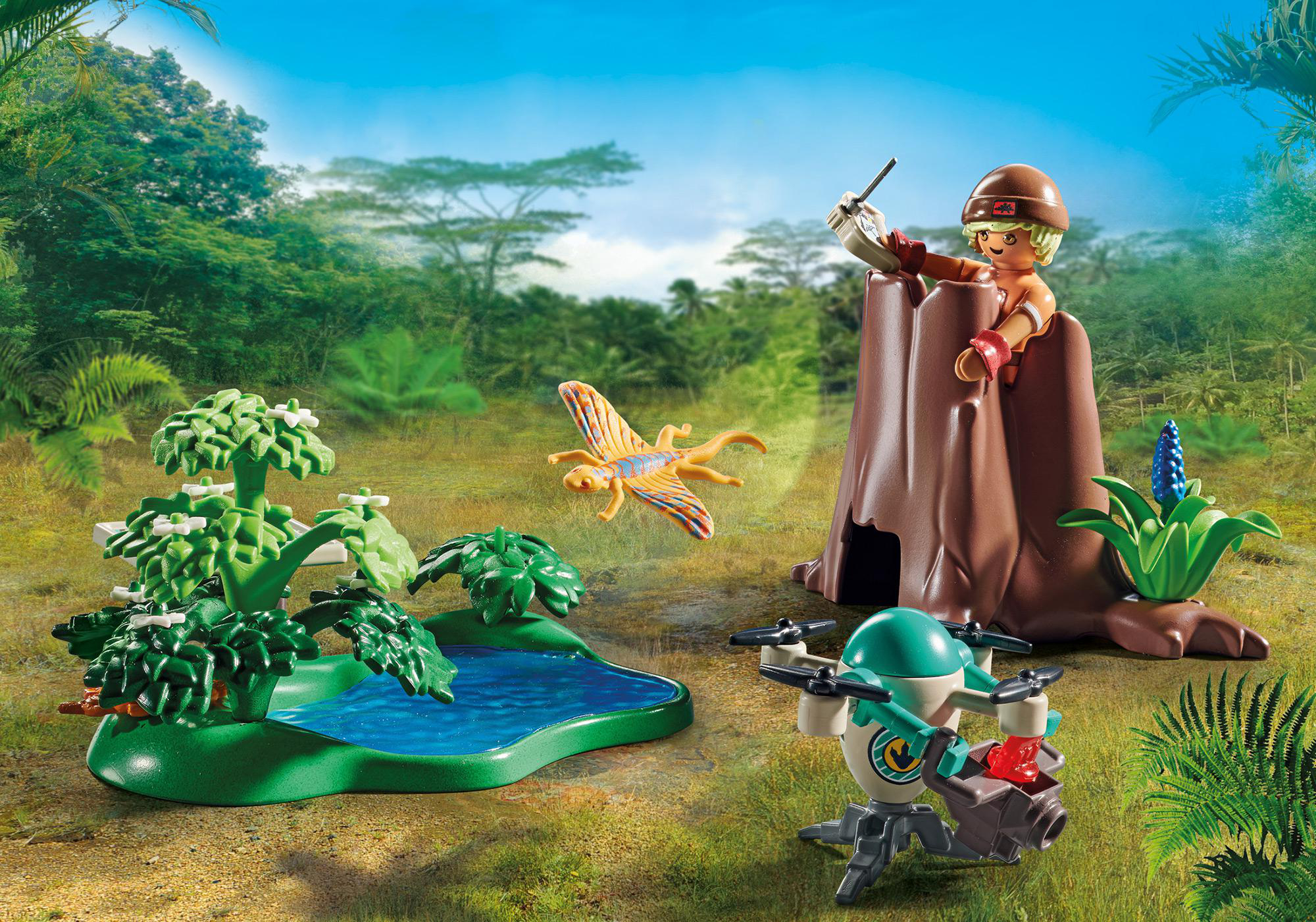 Playmobil-Szene mit einer Person, einer Drohne, einem kleinen See und Bäumen.