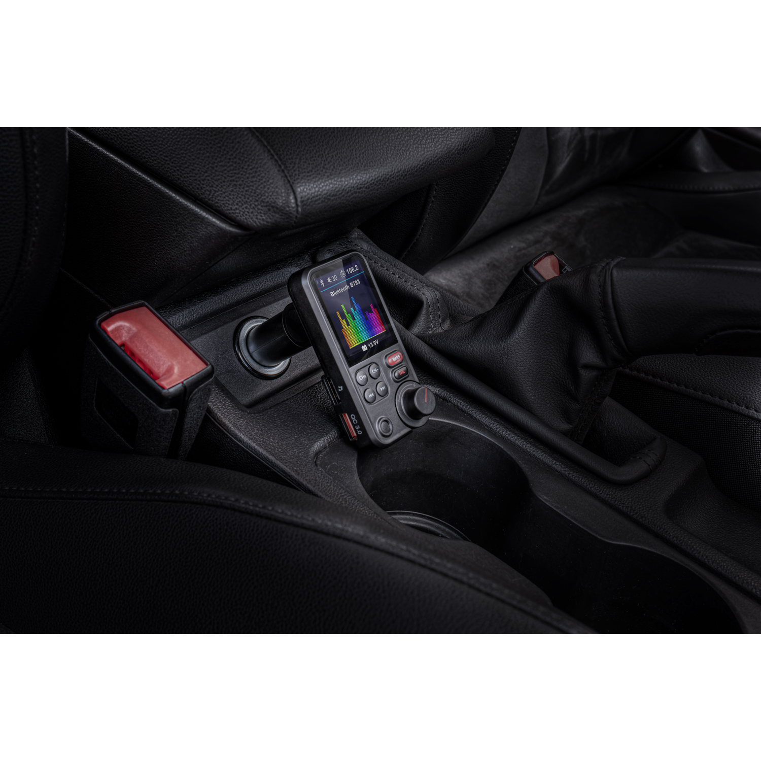 A device in a car's console, with a screen displaying a colorful sound wave.