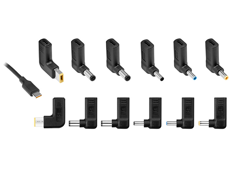 Wiele czarnych zasilaczy do laptopów z różnymi typami złączy, ułożonych w rzędach.