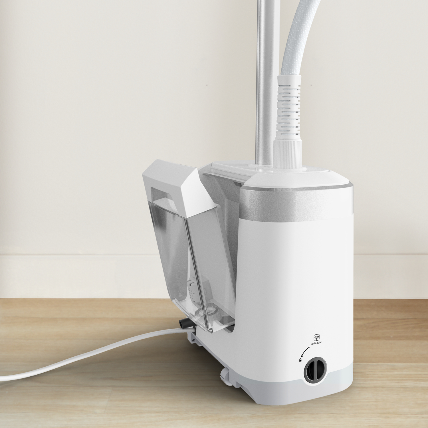 A white clothes steamer with a water tank, sitting on a wooden floor.