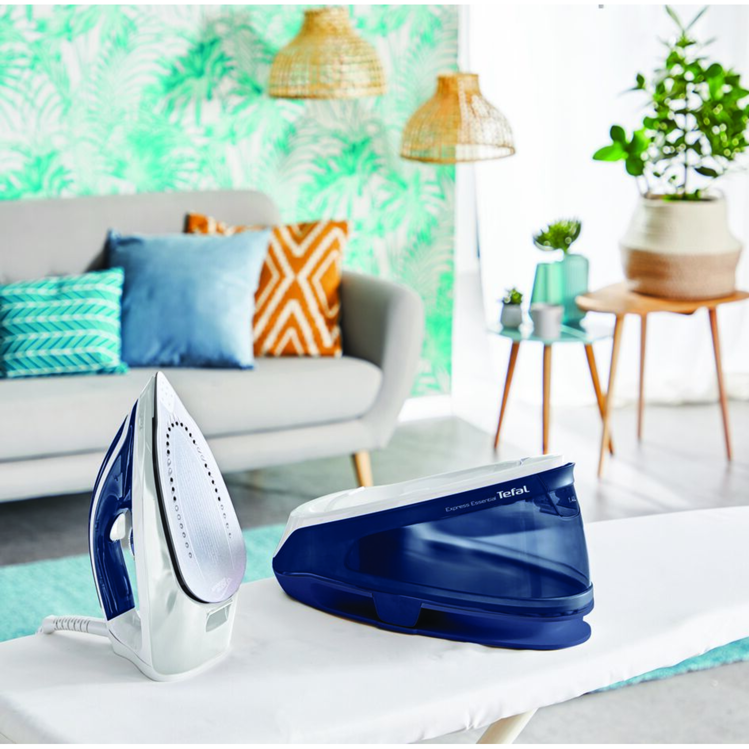 An iron and steam generator on an ironing board in a room with plants.