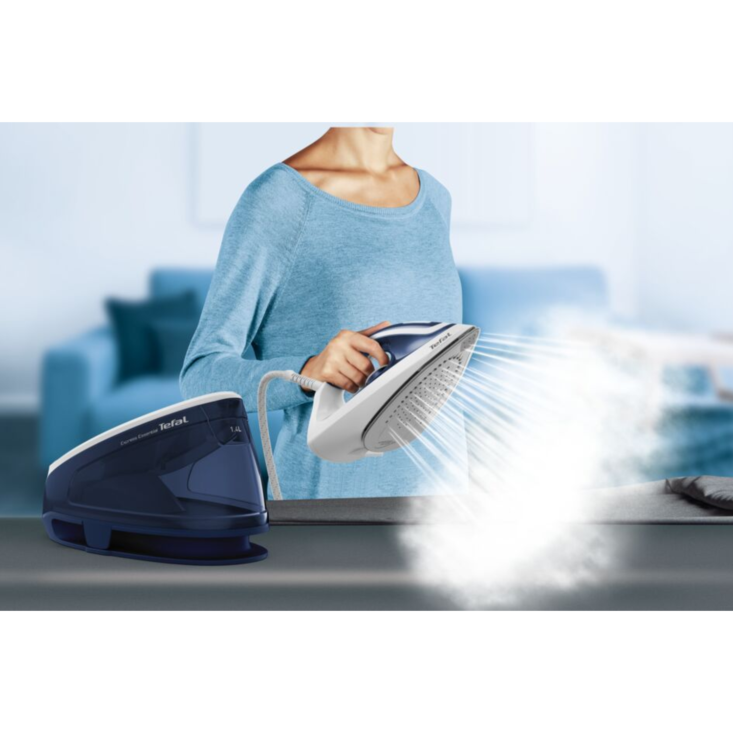 A person ironing with a white and blue iron, steam rising from it.