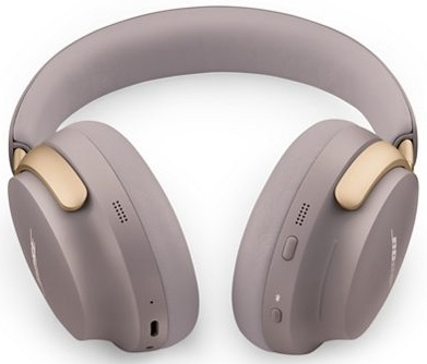 Para jasno szarych i złotych słuchawek na białym tle. Słuchawki są w stylu nausznym.