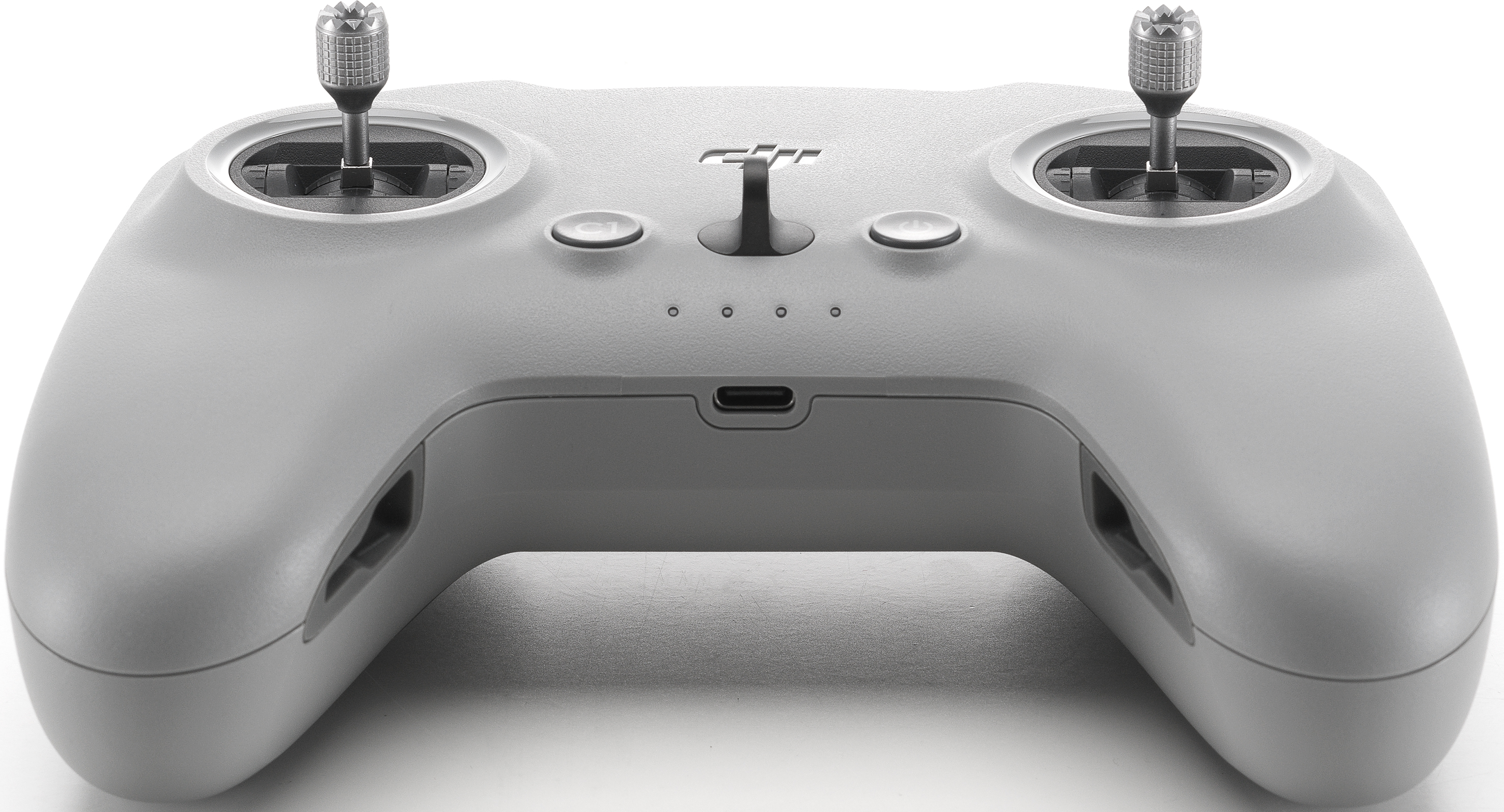 Un controller drone grigio con due joystick, diversi pulsanti e una porta USB.