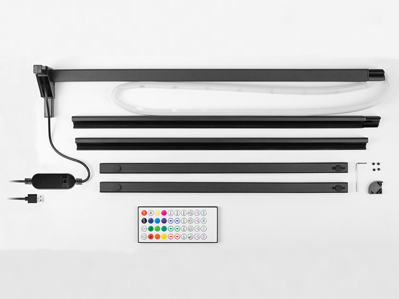 Zestaw oświetlenia LED z różnymi komponentami ułożonymi na białej powierzchni.