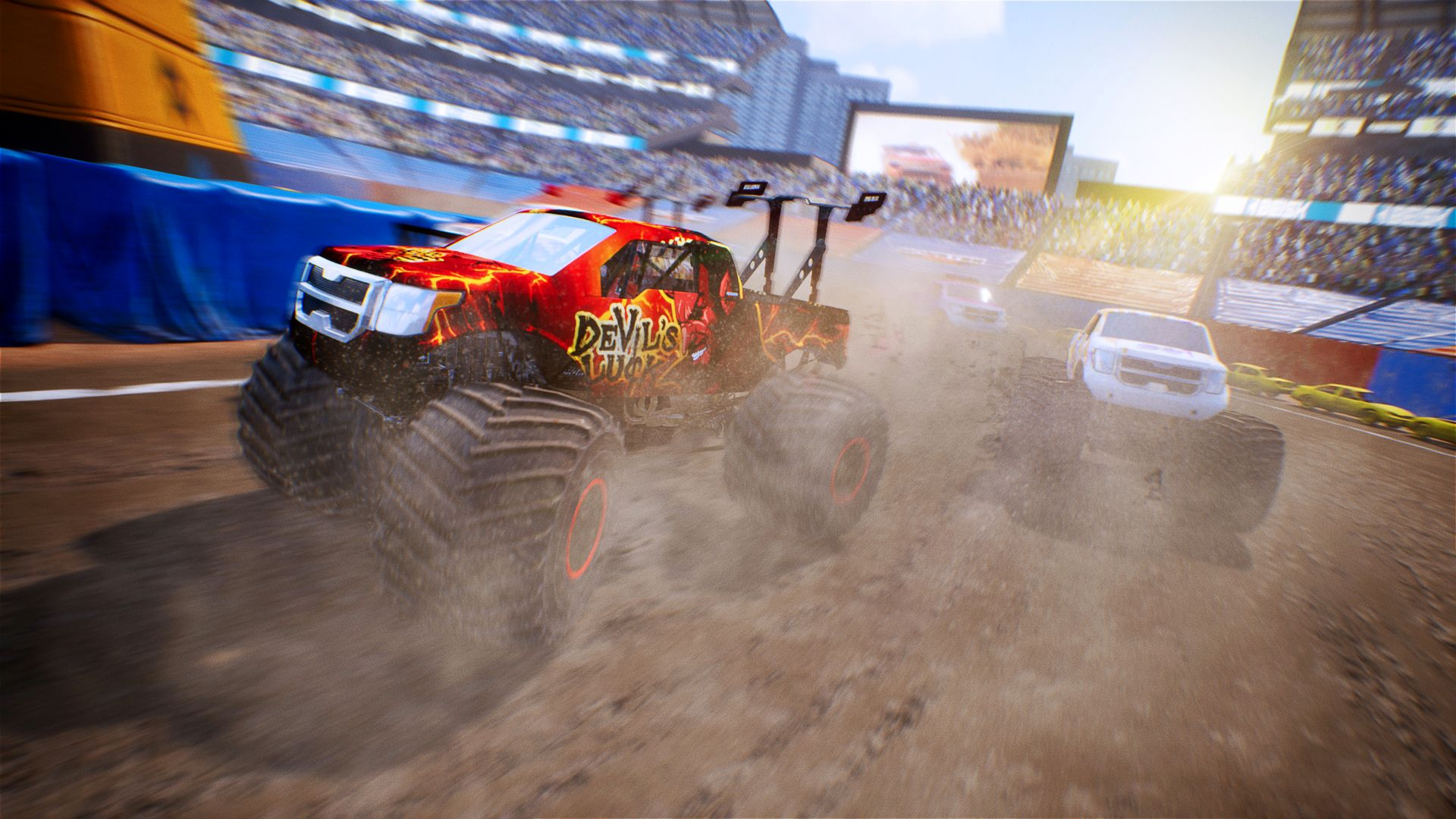 Monster truck in corsa in uno stadio. Un camion ha un design 'Devil's Truck'.