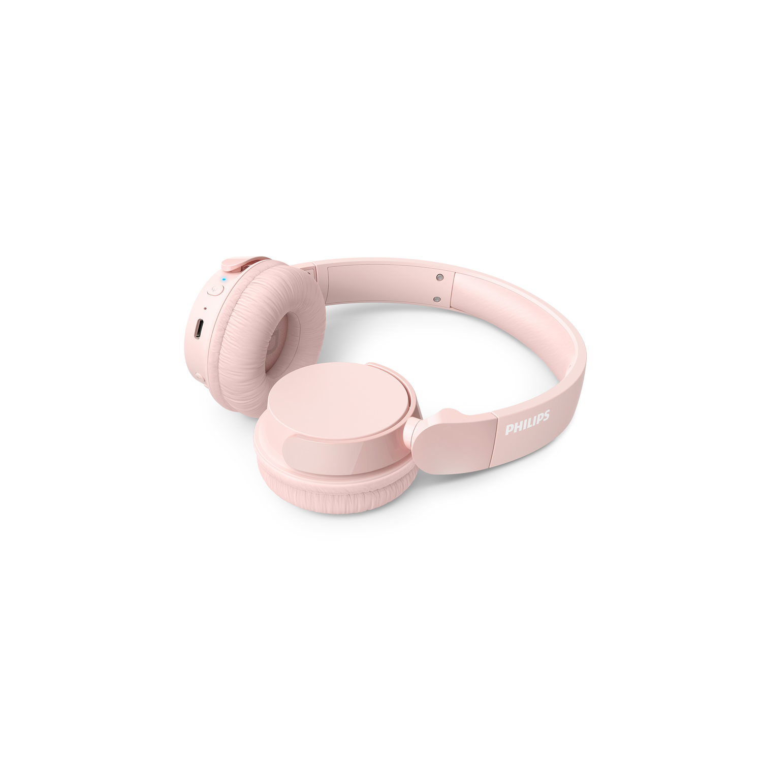 Pink headphones resting on a white surface. The headphones are on-ear style.