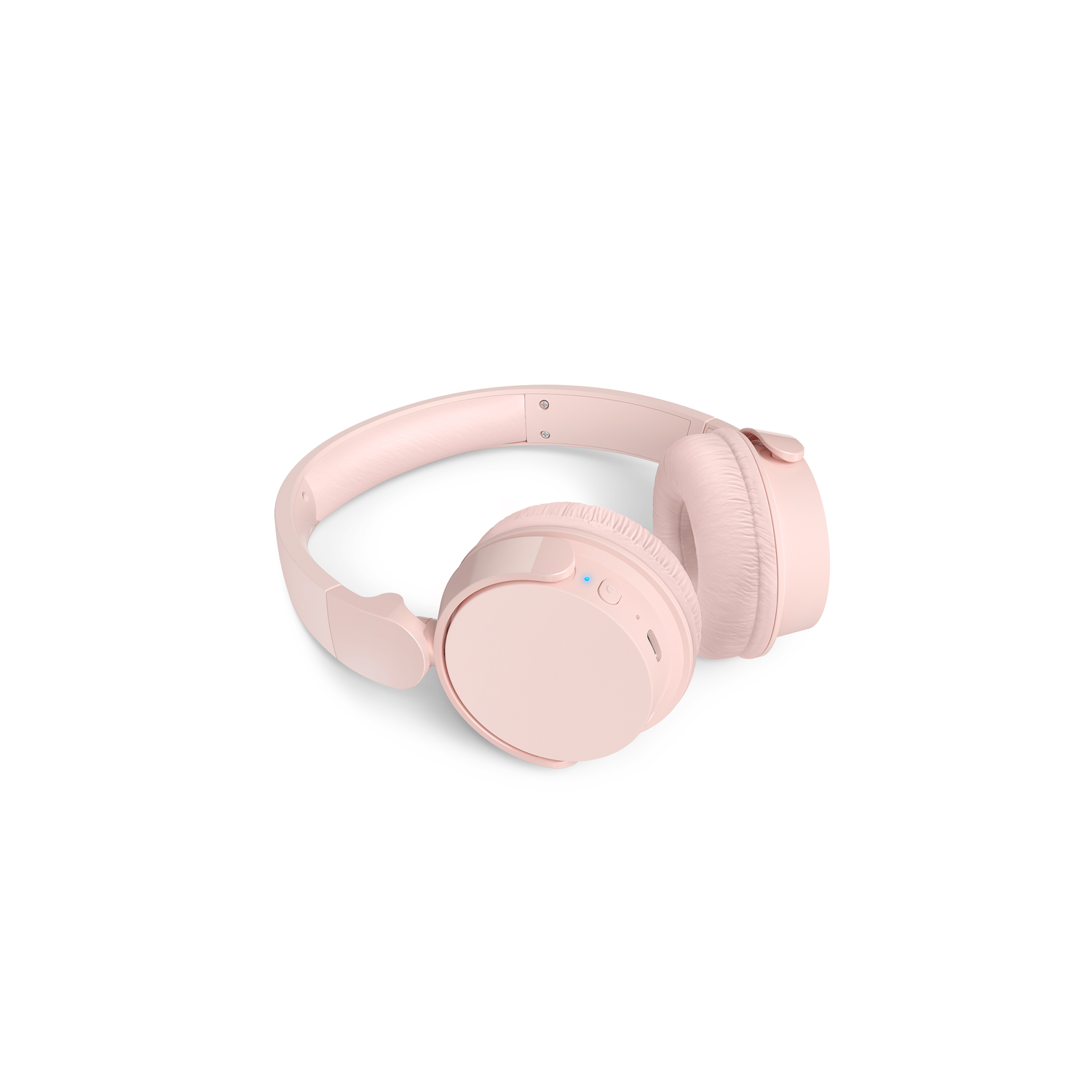 Pink wireless headphones lying on a white surface, showing ear cups and band.