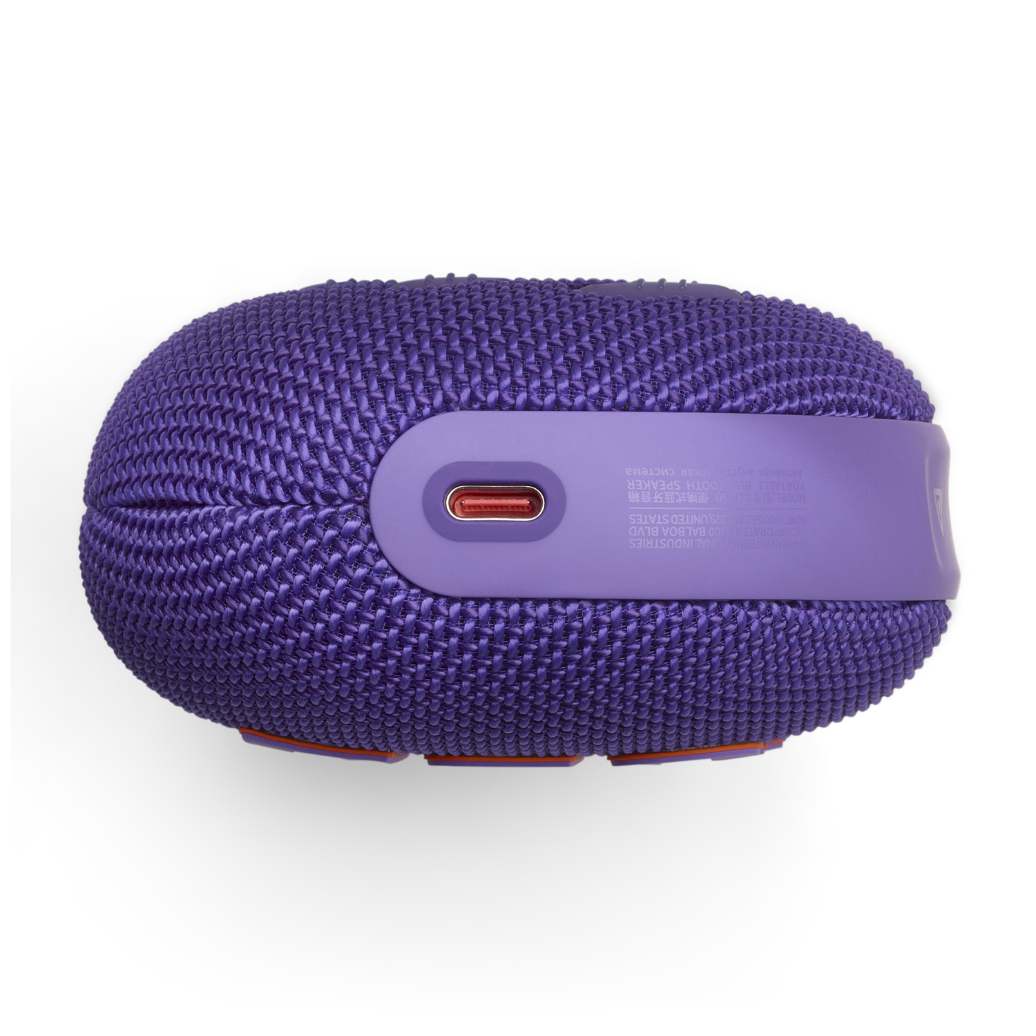 Purple speaker, top view. Features a purple woven fabric with a charging port.