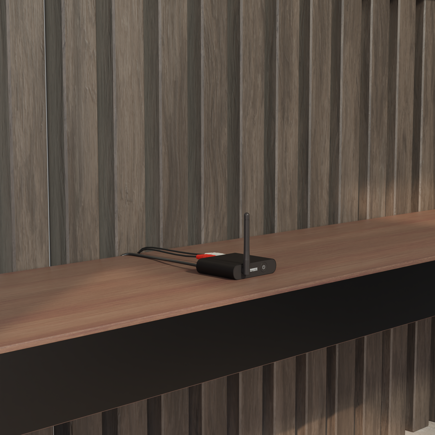 Black device on a wooden shelf with wires, against a wood-paneled wall.