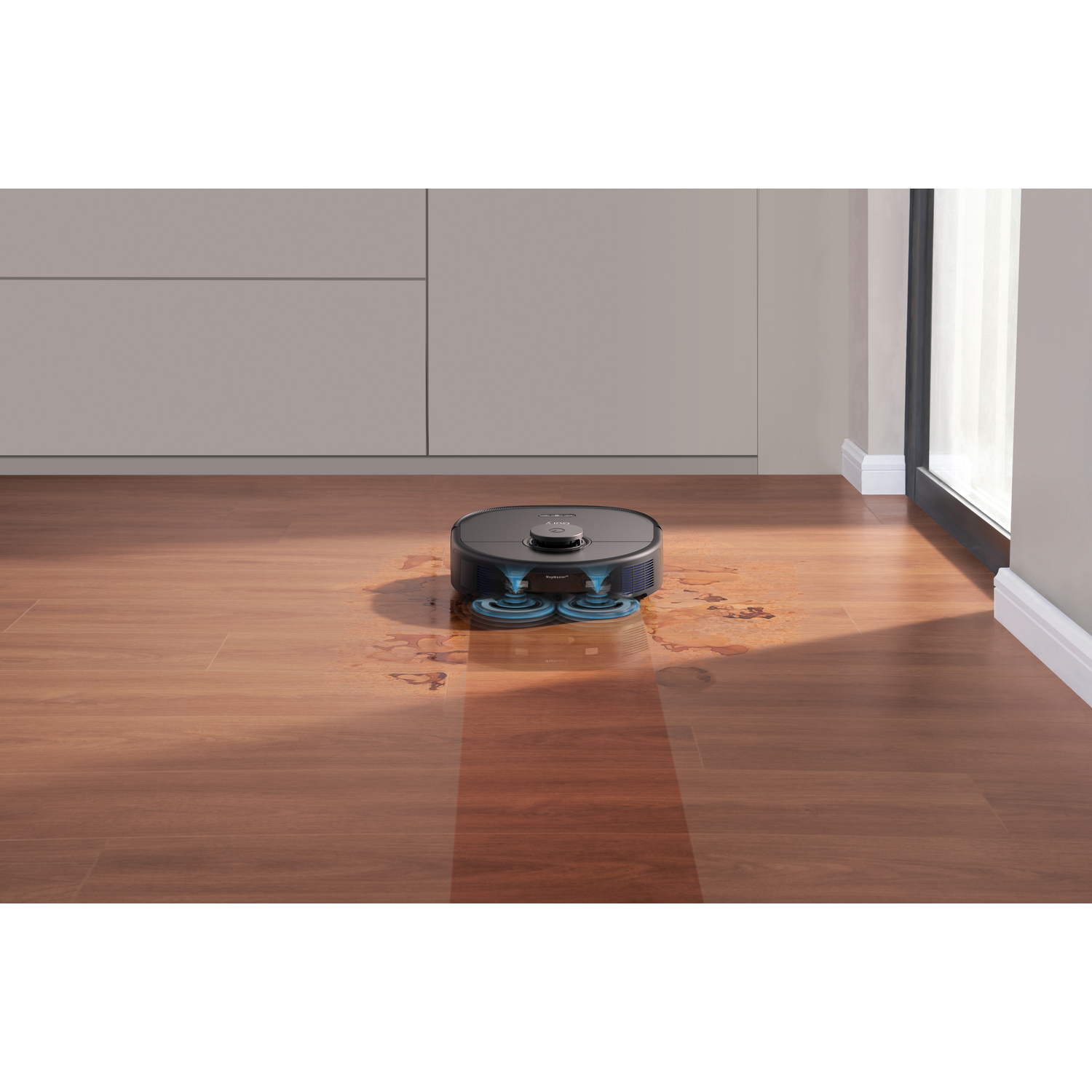 Aspirateur robot sur sol en bois. Montre le trajet de nettoyage et les taches humides.