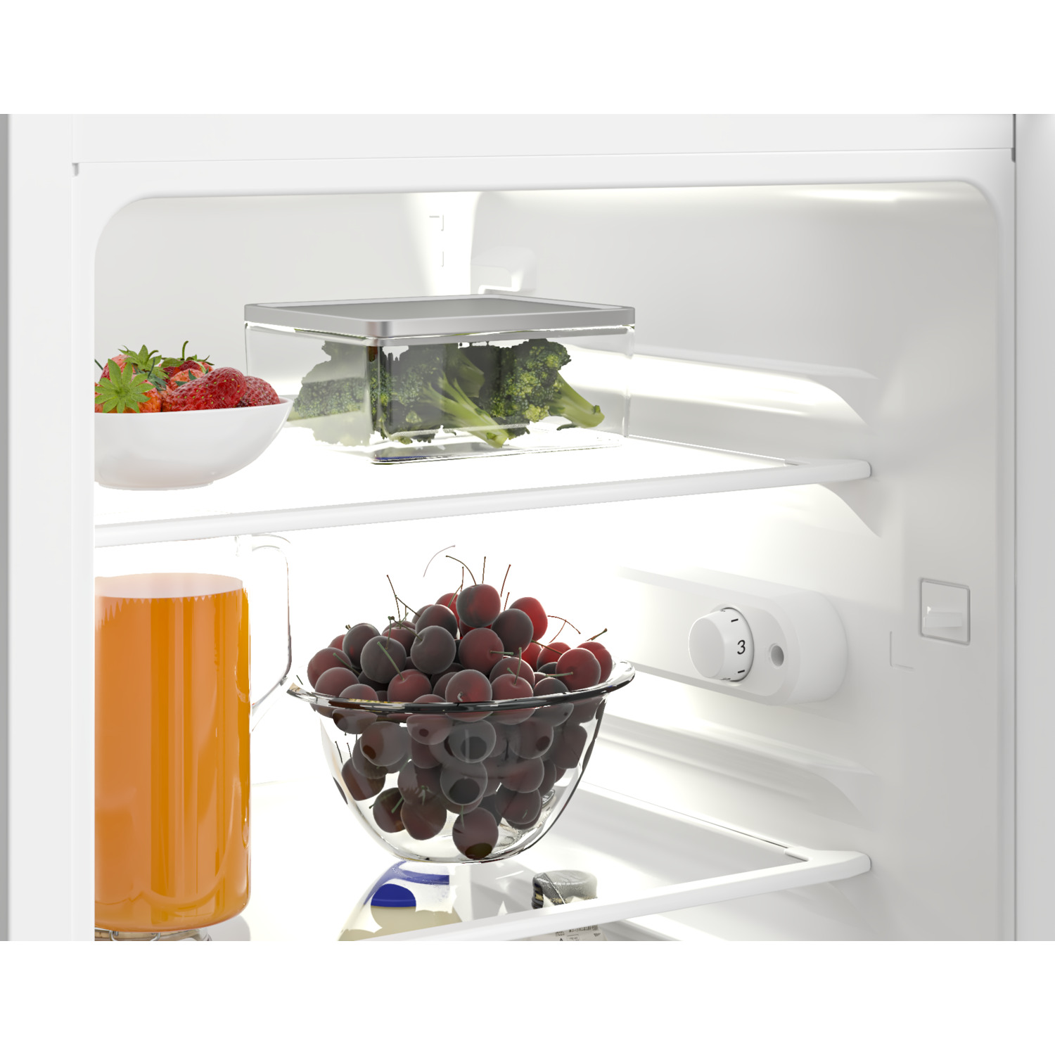 Inside a refrigerator: strawberries, broccoli, and cherries in glass bowls.