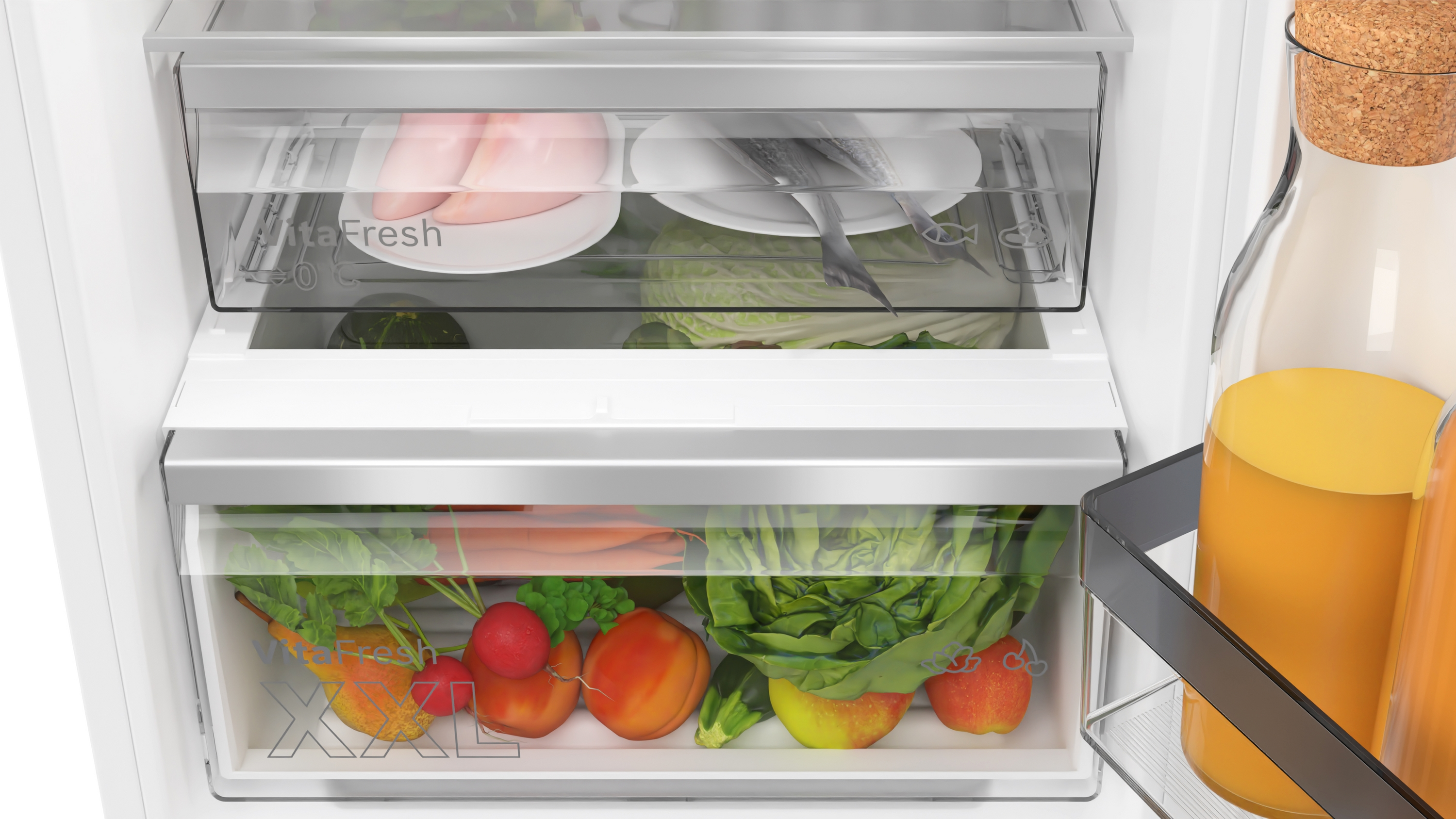 Intérieur de réfrigérateur avec tiroirs. Légumes et fruits visibles à l'intérieur.
