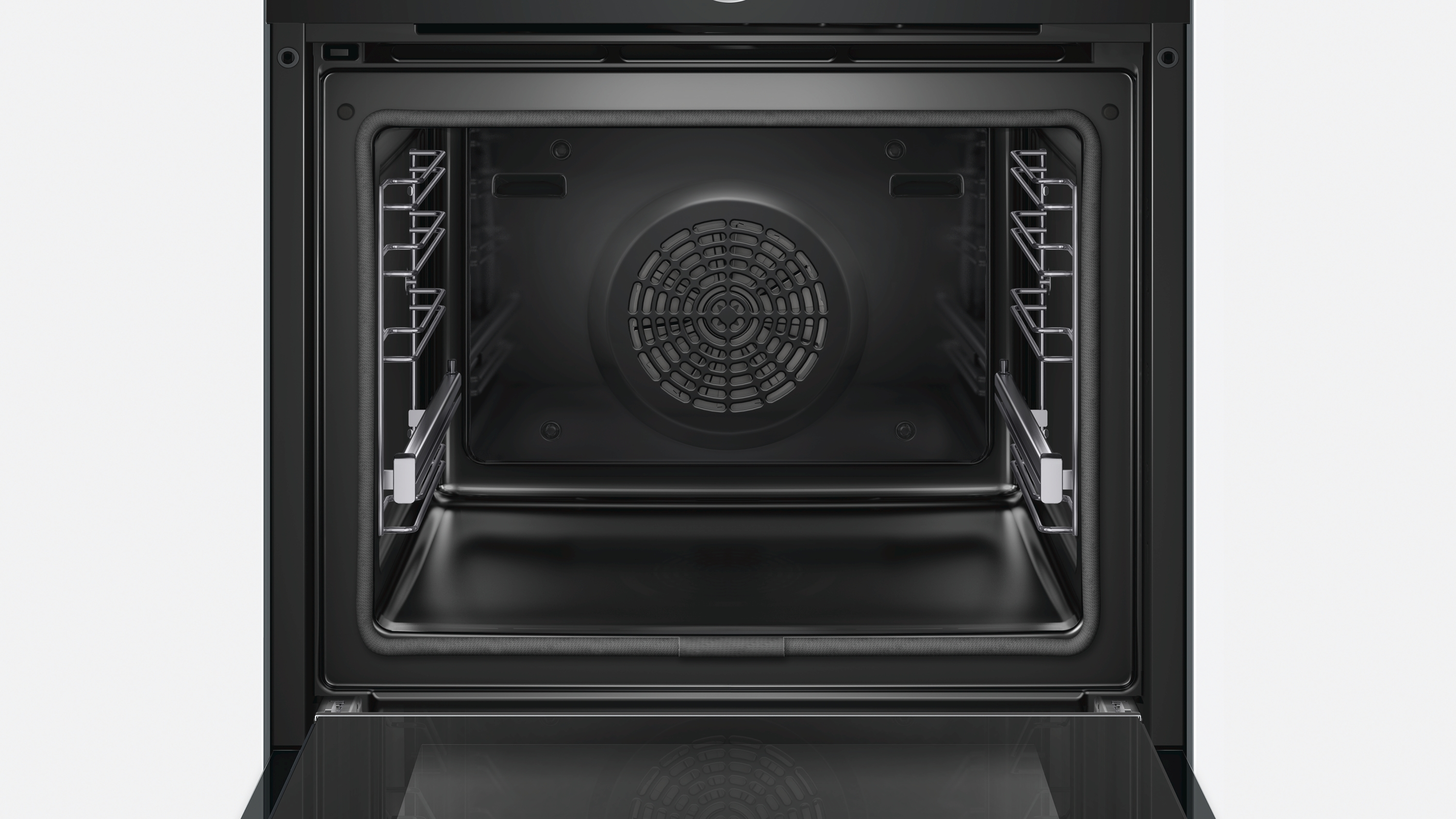 Intérieur de four noir. À l'intérieur, il y a des grilles et un ventilateur. L'intérieur est sombre et propre.
