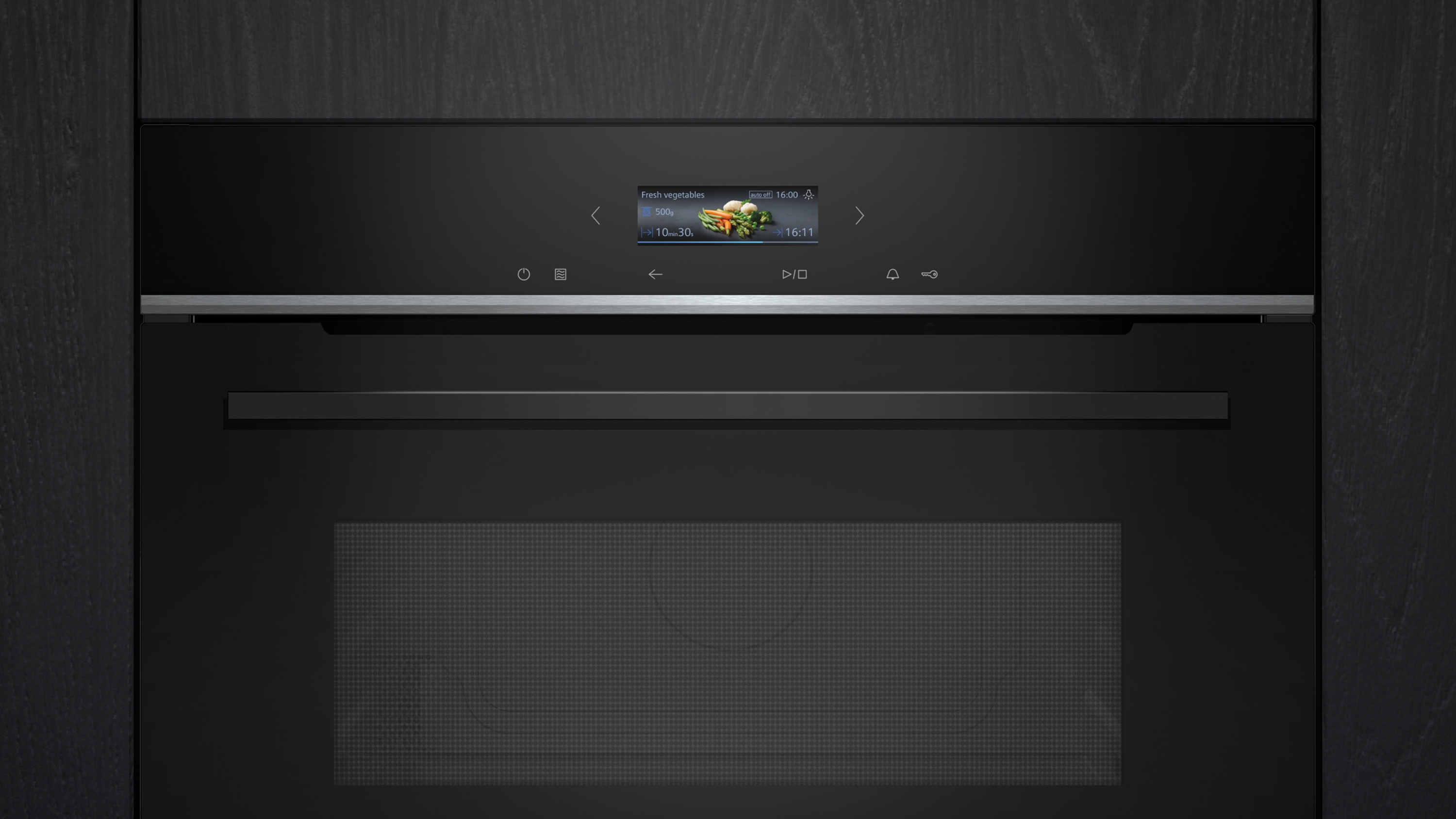 Schwarzer Backofen mit Digitalanzeige, die das Menü 'Frisches Gemüse' zeigt.